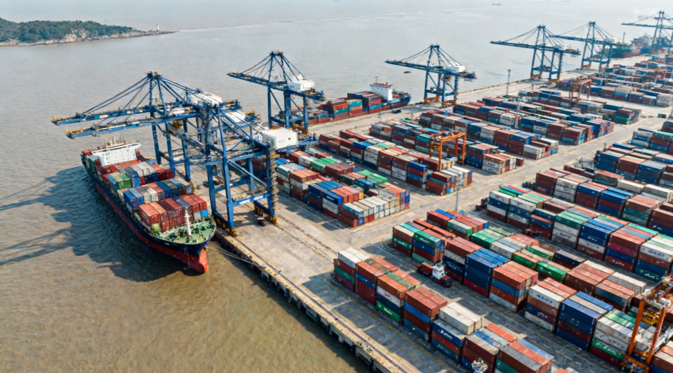 Busy container terminal at Ningbo Port with cargo ships and cranes supporting ocean freight from Ningbo to Vancouver.