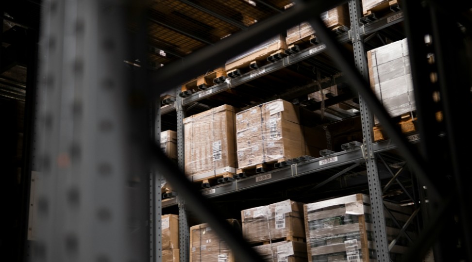 Palletized cargo stored in a warehouse racking system for break bulk logistics handling.